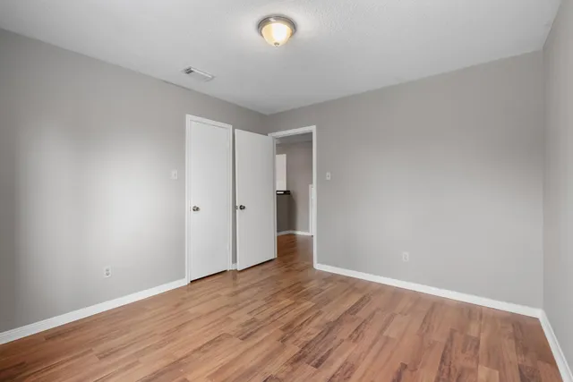 a bathroom with a granite countertop sink a toilet and a mirror