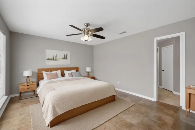 a bedroom with a bed and a painting on the wall