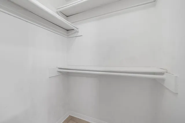 a kitchen with stainless steel appliances and white cabinets