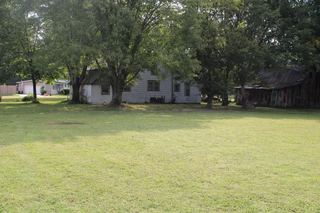 a view of a yard with a table and chair