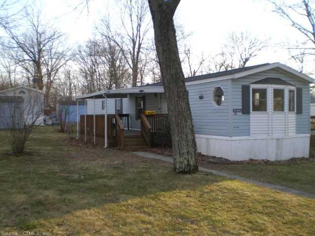 a view of a small house with a yard