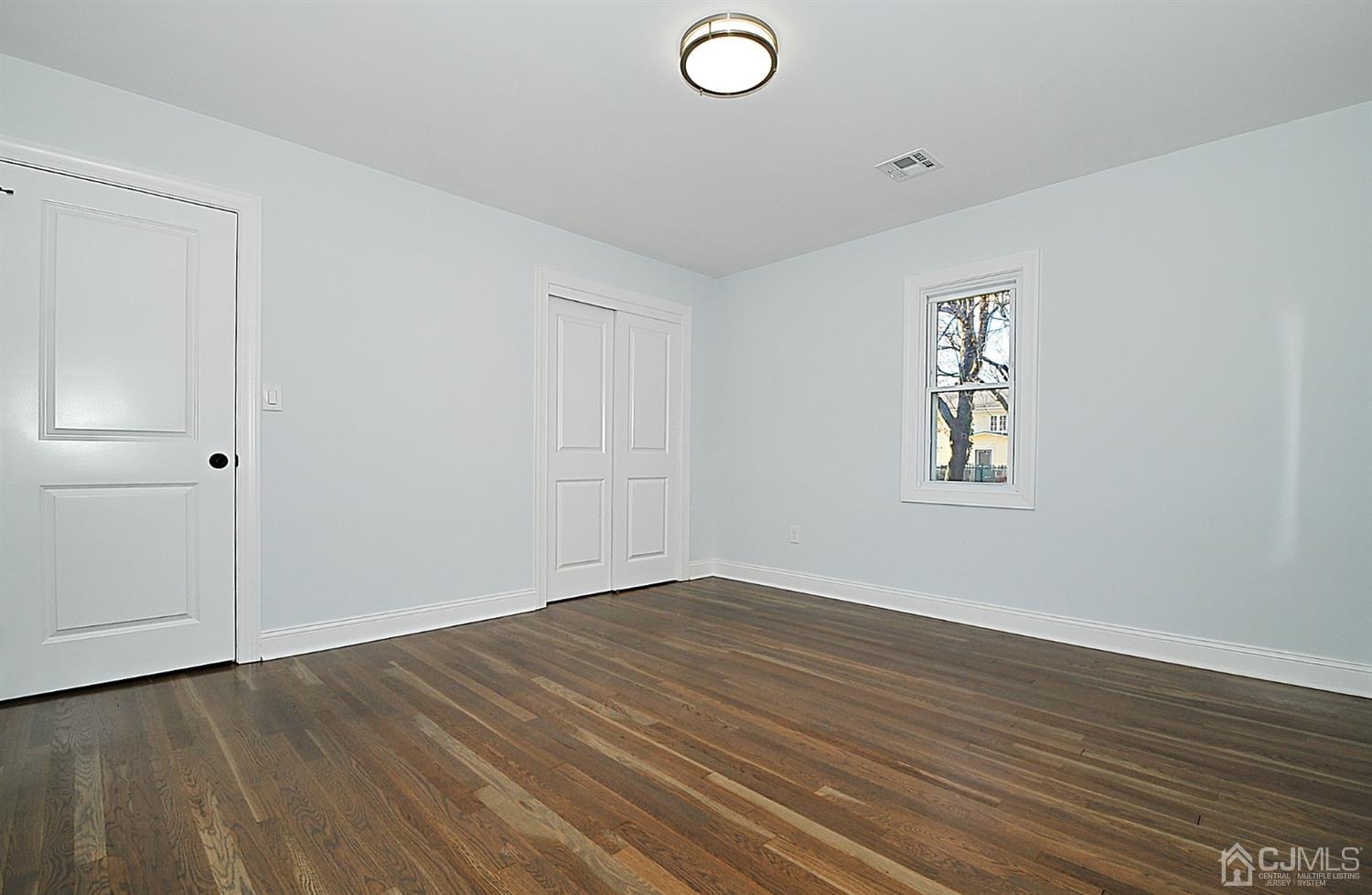 24 Prescott Street Edison, NJ 08817 - Photo 12 of 27 an empty room with wooden floor and windows