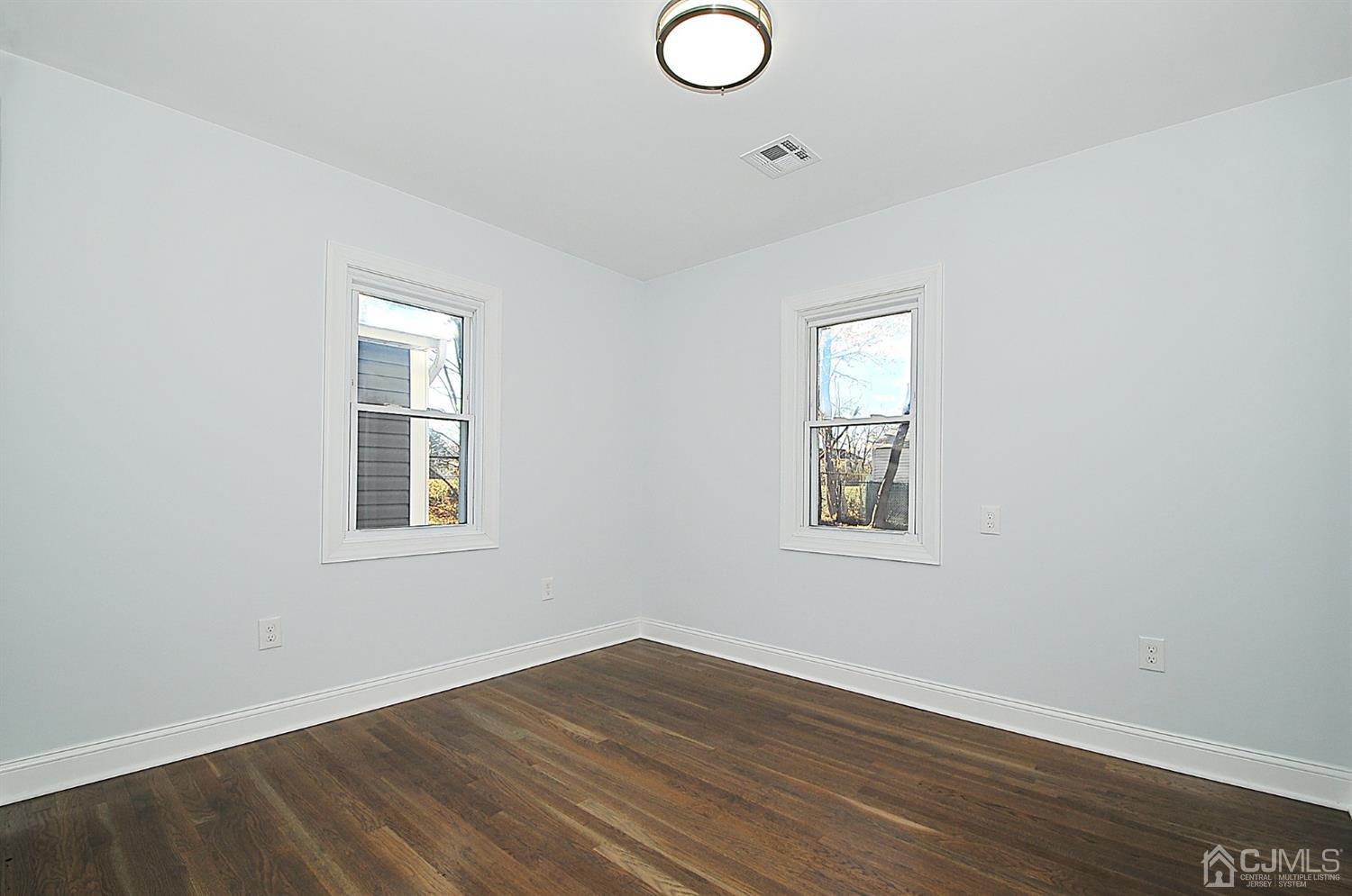 24 Prescott Street Edison, NJ 08817 - Photo 13 of 27 an empty room with wooden floor and windows