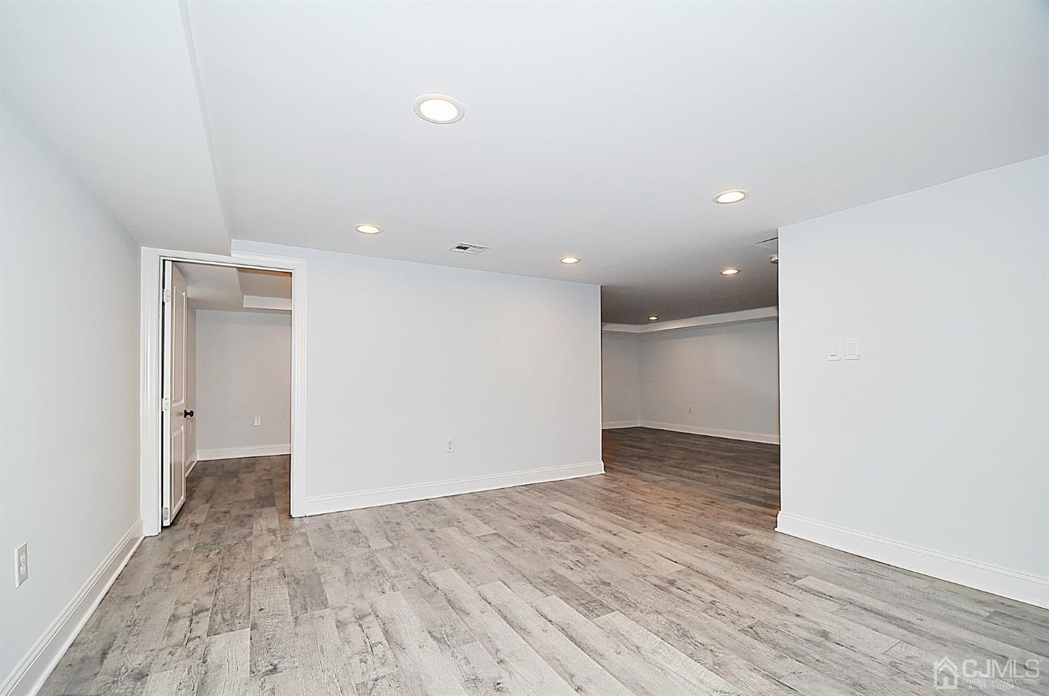 24 Prescott Street Edison, NJ 08817 - Photo 21 of 27 wooden floor in an empty room with a window