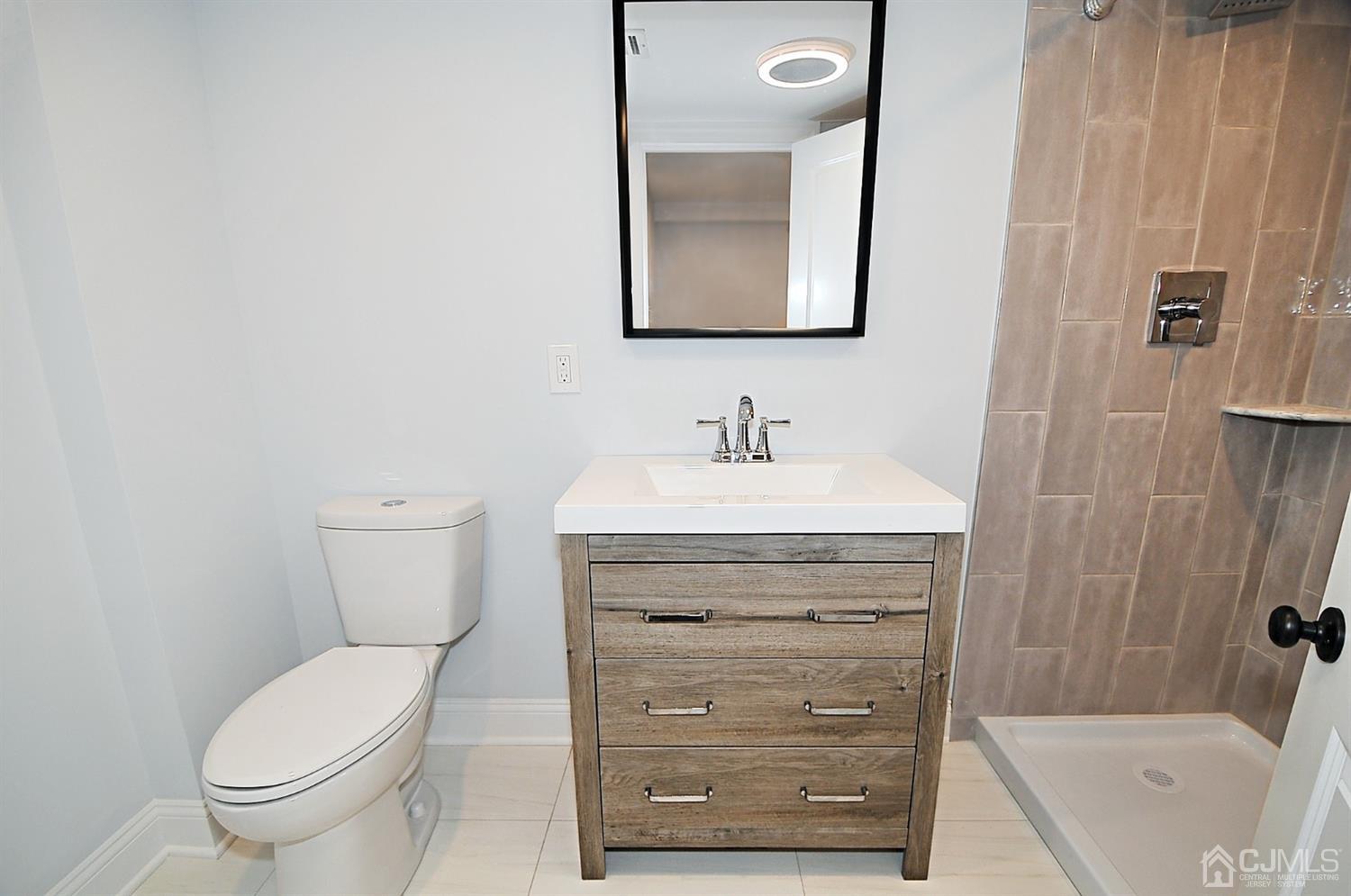24 Prescott Street Edison, NJ 08817 - Photo 23 of 27 a bathroom with a toilet a sink and mirror