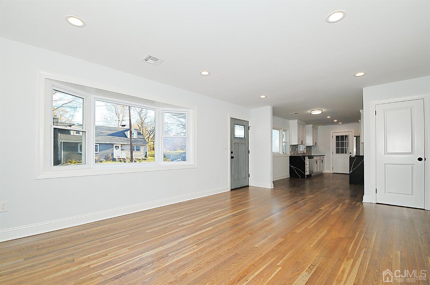 24 Prescott Street Edison, NJ 08817 - Photo 4 of 27 a view of an empty room with wooden floor and a window