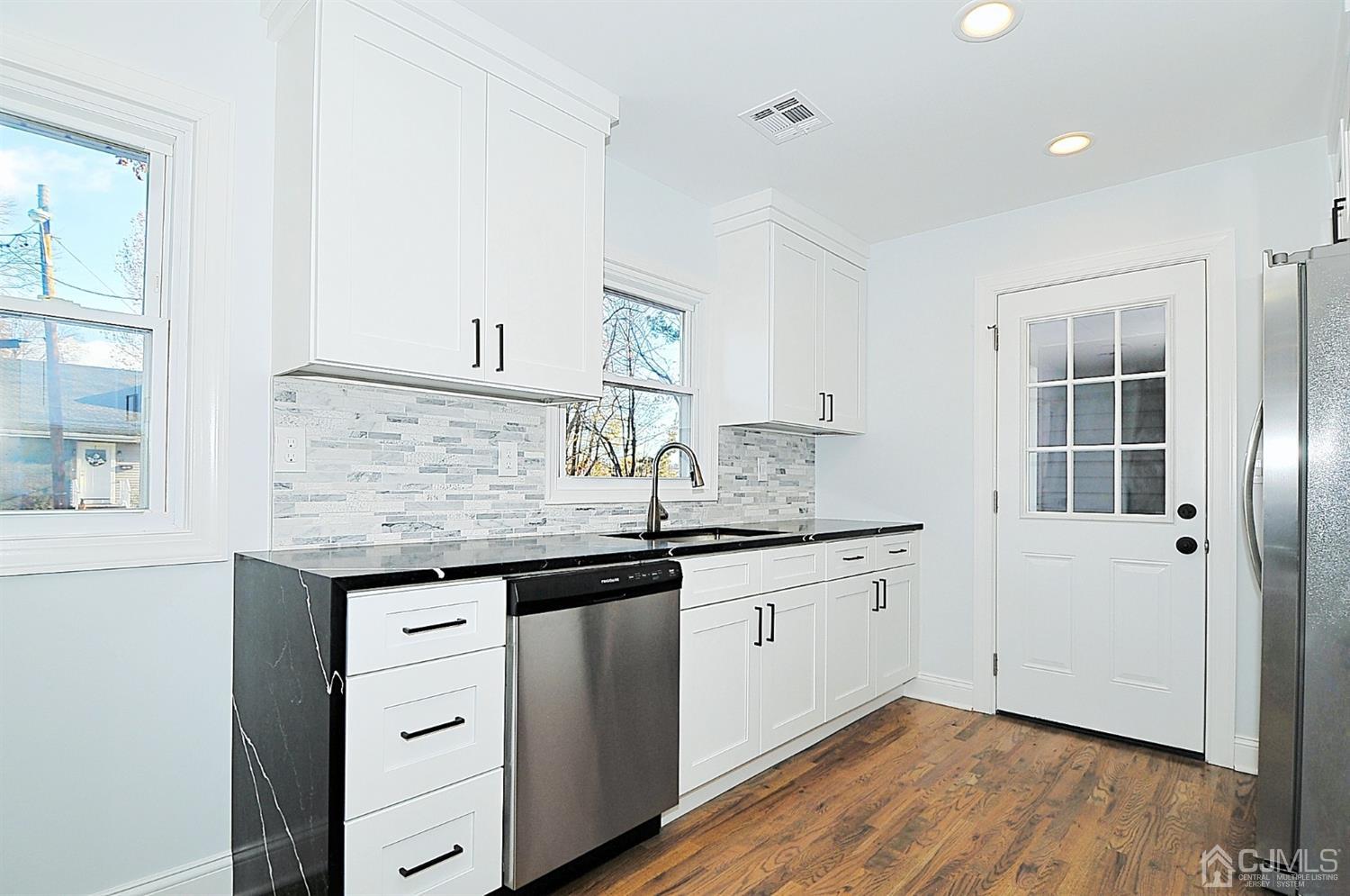 24 Prescott Street Edison, NJ 08817 - Photo 8 of 27 a kitchen with granite countertop a sink and cabinets