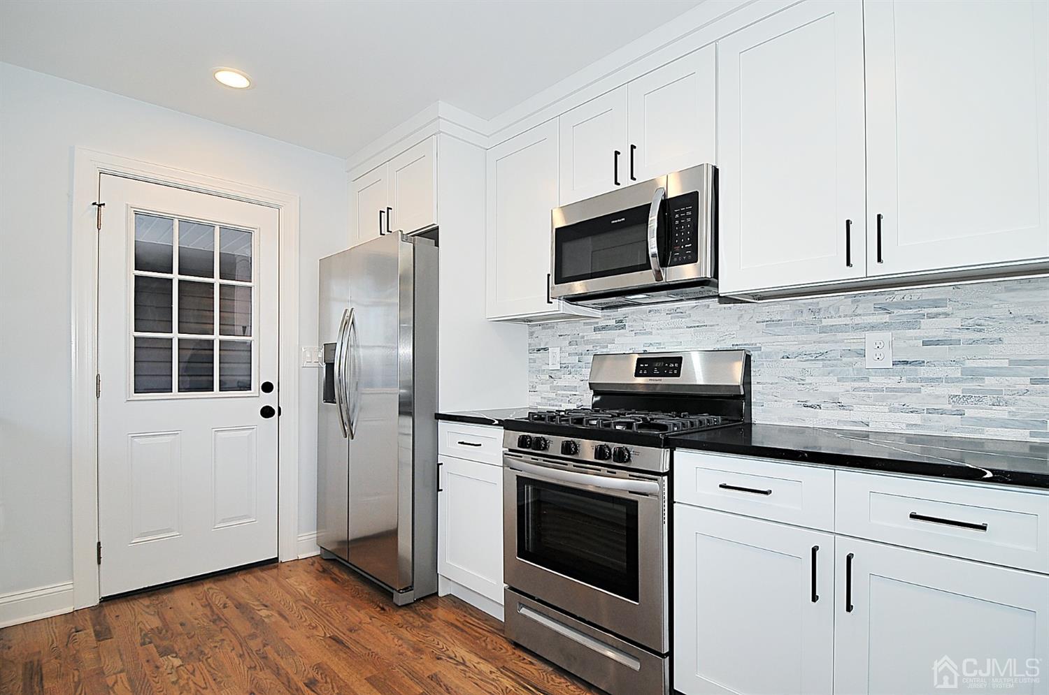 24 Prescott Street Edison, NJ 08817 - Photo 9 of 27 a kitchen with stainless steel appliances white cabinets stove and refrigerator
