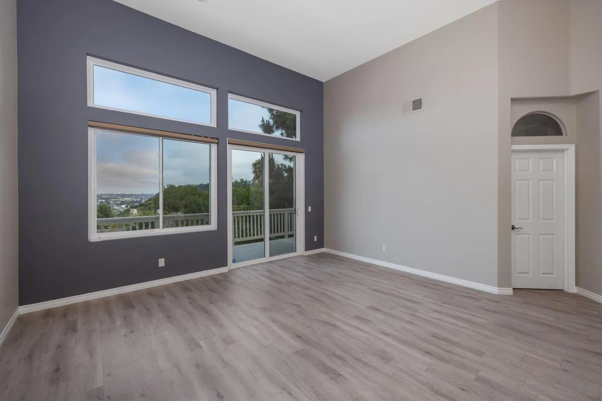 6013 Oakgate Row La Jolla, CA 92037 - Photo 12 of 50 a view of empty room with wooden floor and fan