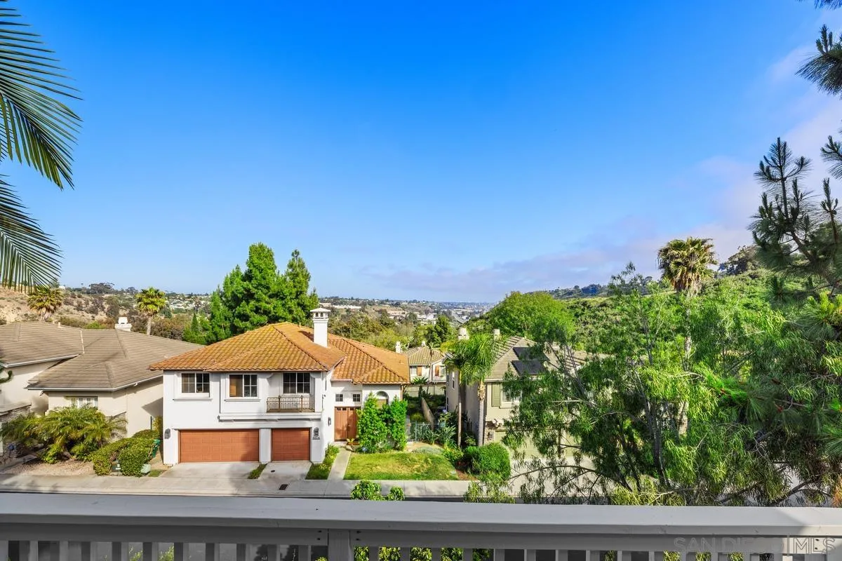 6013 Oakgate Row La Jolla, CA 92037 - Photo 13 of 50 a front view of a house with a yard