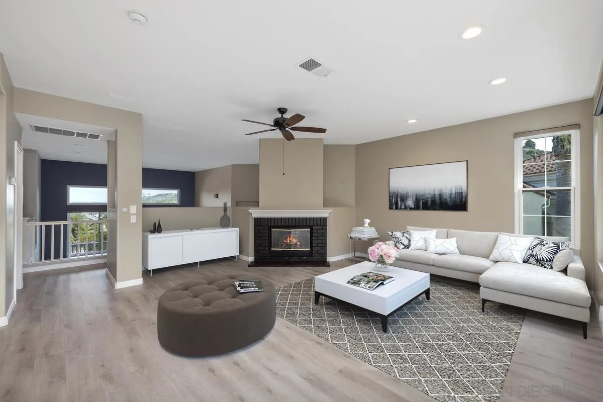 6013 Oakgate Row La Jolla, CA 92037 - Photo 17 of 50 a living room with furniture and a fireplace