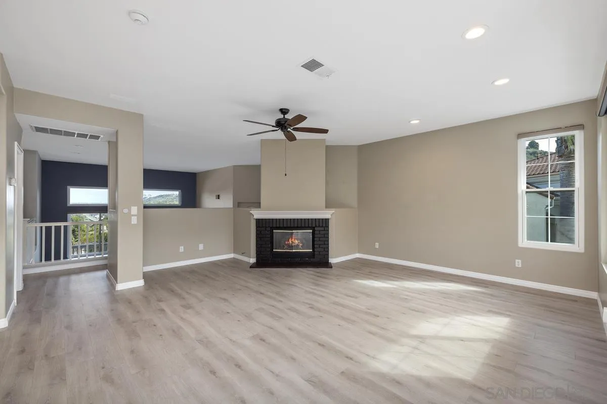 6013 Oakgate Row La Jolla, CA 92037 - Photo 18 of 50 a view of an empty room with a window and wooden floor