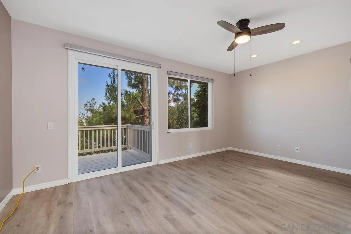 6013 Oakgate Row La Jolla, CA 92037 - Photo 26 of 50 a view of empty room with wooden floor and fan