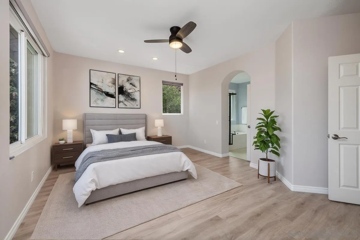 6013 Oakgate Row La Jolla, CA 92037 - Photo 27 of 50 a bedroom with a bed and a chandelier