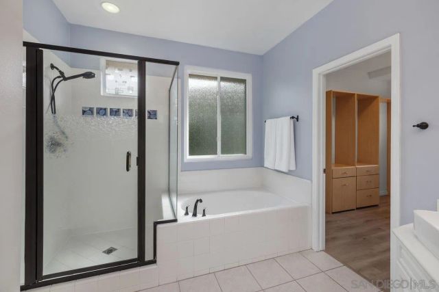 a bathroom with bathtub and a shower