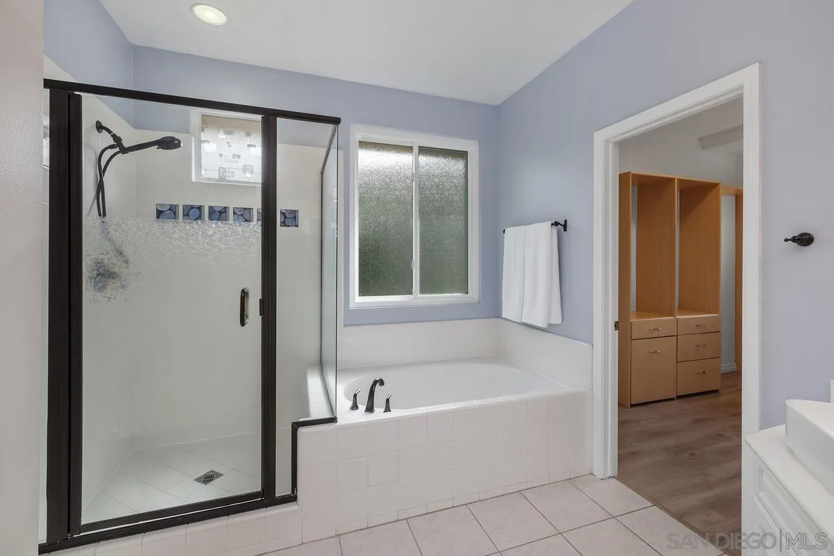 6013 Oakgate Row La Jolla, CA 92037 - Photo 30 of 50 a bathroom with bathtub and a shower