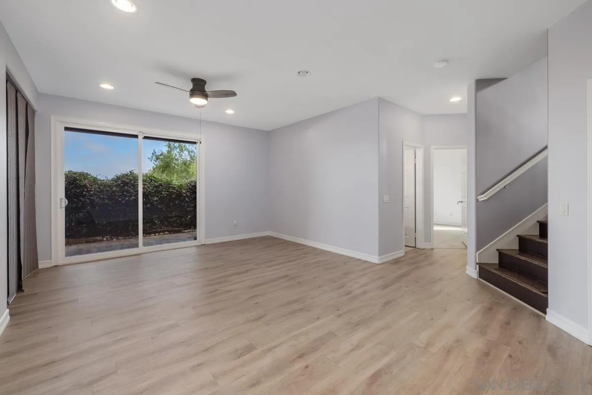 6013 Oakgate Row La Jolla, CA 92037 - Photo 33 of 50 a view of an empty room with wooden floor and a window