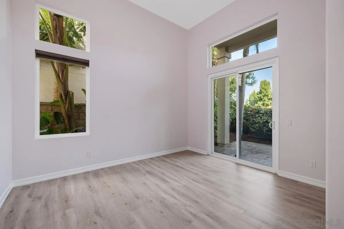6013 Oakgate Row La Jolla, CA 92037 - Photo 34 of 50 an empty room with wooden floor and a window