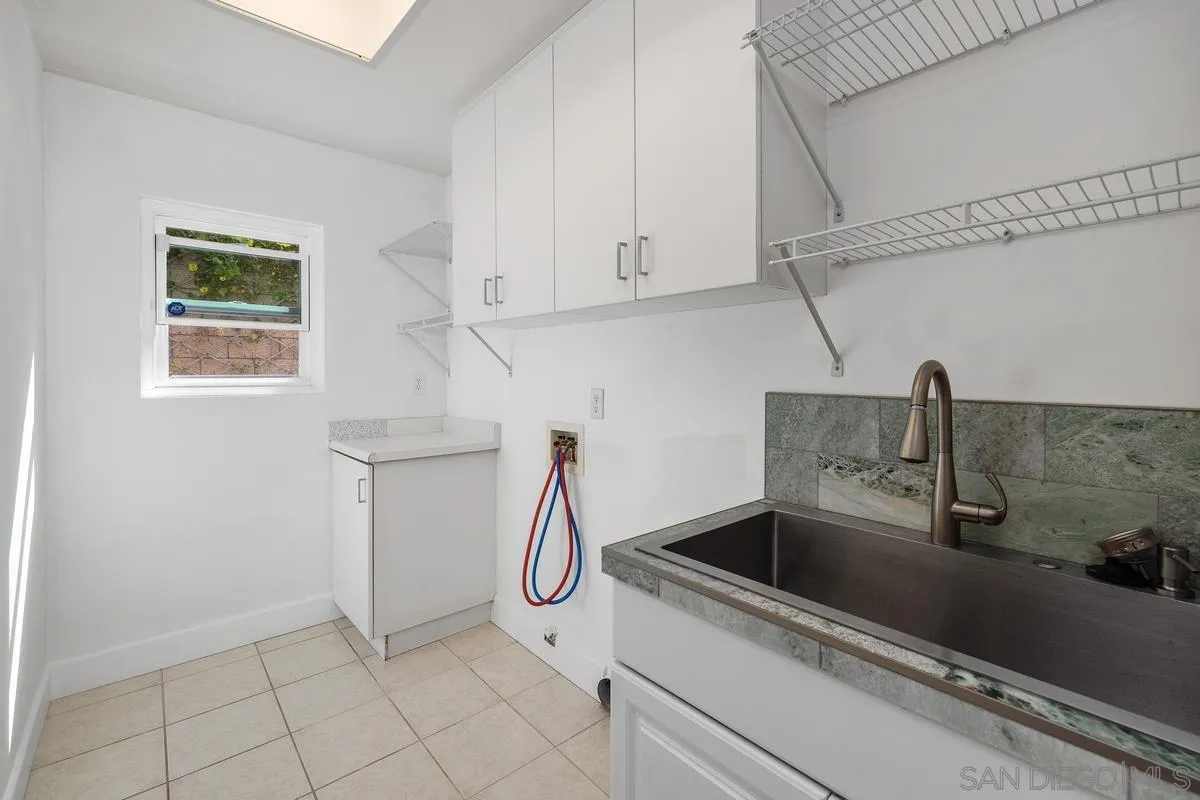 6013 Oakgate Row La Jolla, CA 92037 - Photo 37 of 50 a kitchen with a sink and cabinets