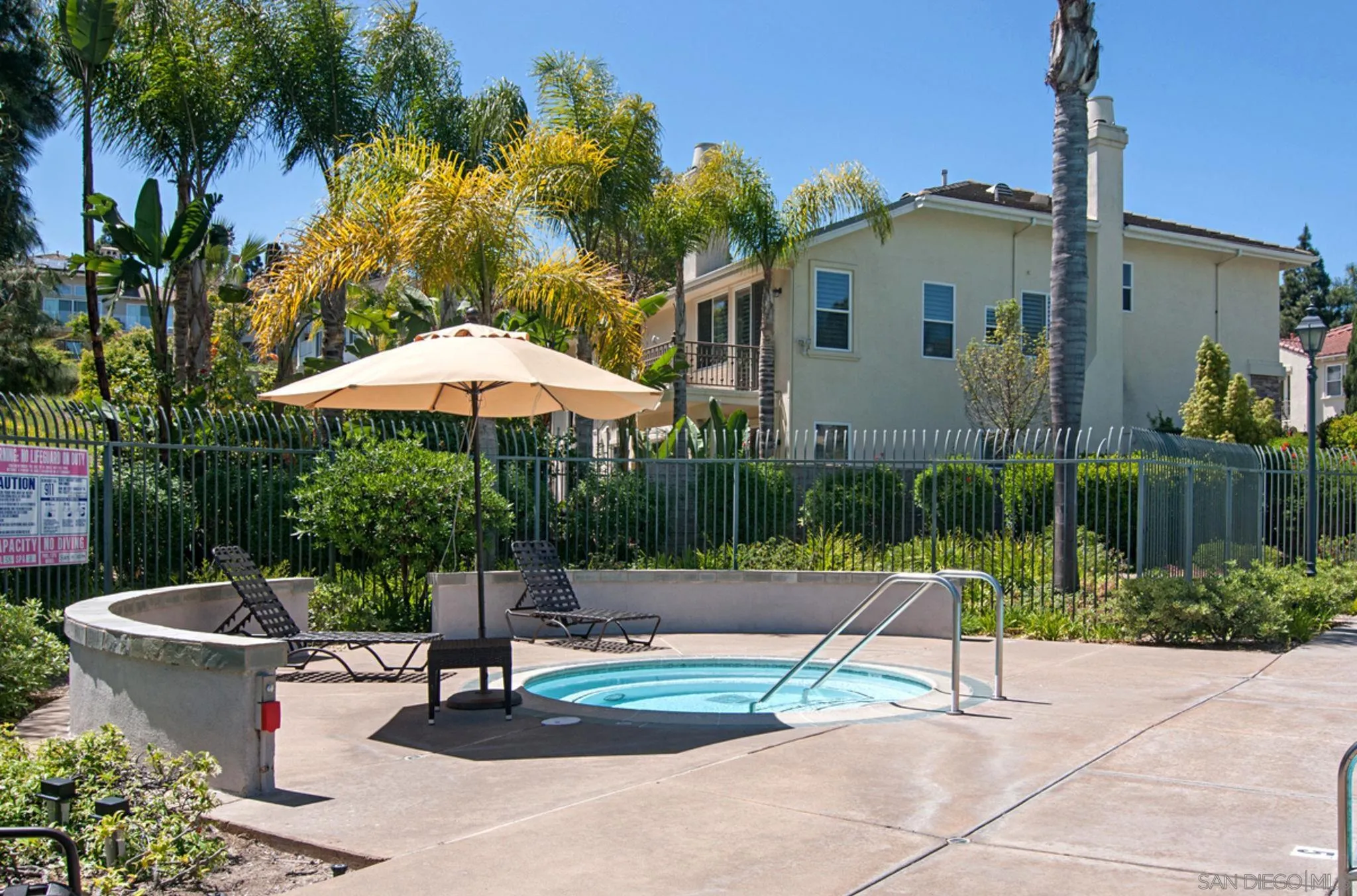 6013 Oakgate Row La Jolla, CA 92037 - Photo 46 of 50 a view of a patio with a table and chairs under an umbrella