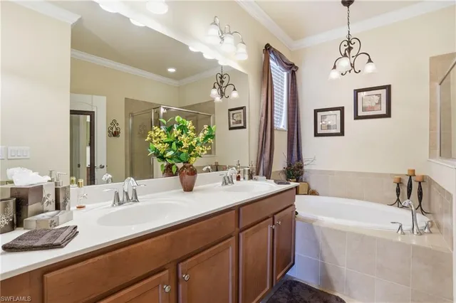 a bathroom with a tub sink and mirror