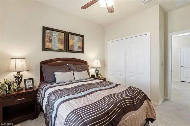 a bedroom with a bed and a lamp