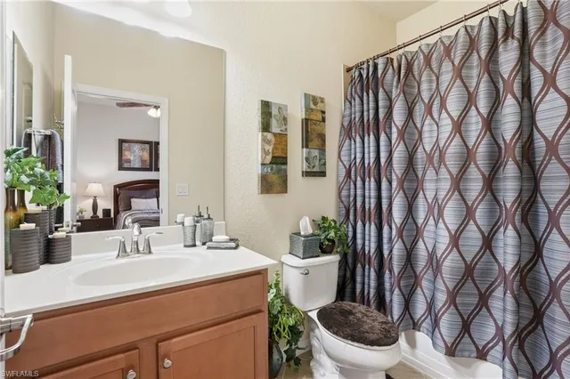 a bathroom with a toilet a sink and a mirror