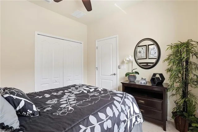 a bedroom with a bed and a potted plant
