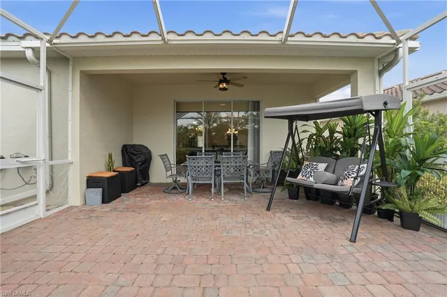 a view of a patio with table and chairs