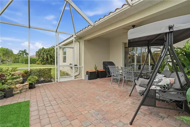 a view of a patio with table and chairs under an umbrella