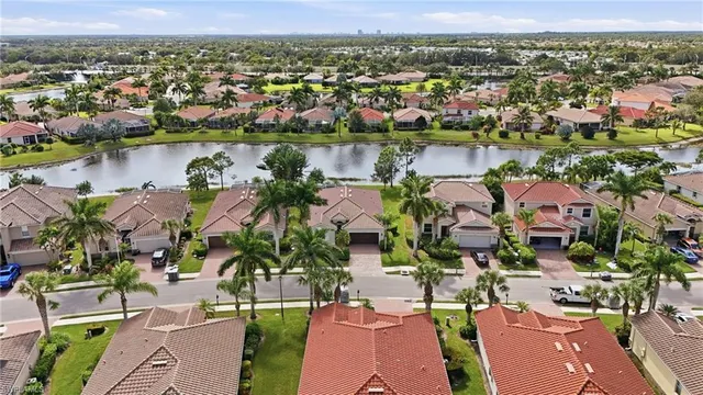 an aerial view of residential house with outdoor space and lake view