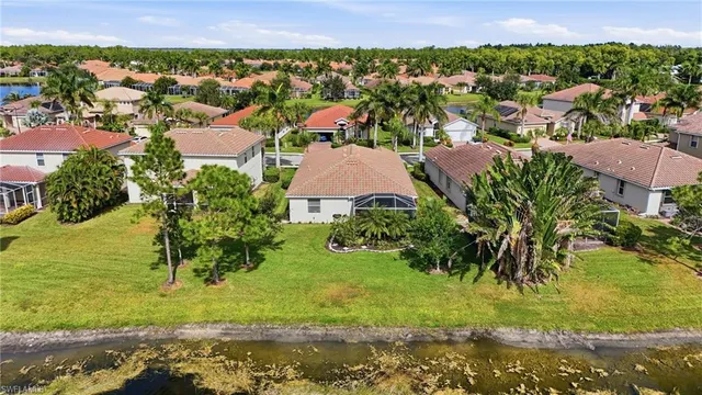 an aerial view of residential houses with outdoor space and swimming pool