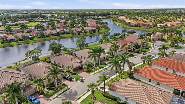 an aerial view of a houses with a lake view