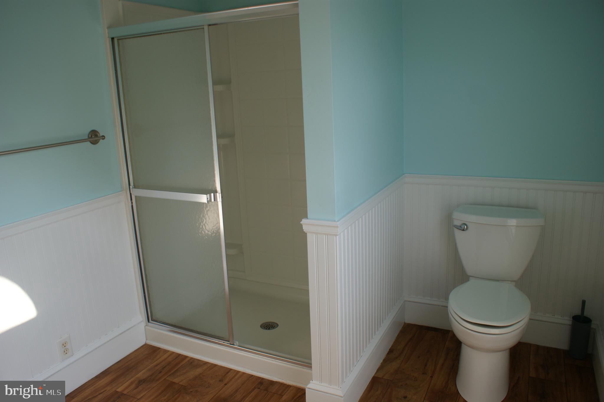 231 West Pine Street Georgetown, DE 19947 - Photo 4 of 26 a white toilet sitting next to a shower