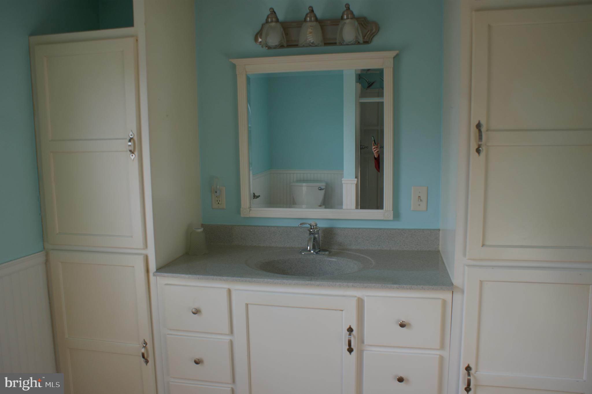 231 West Pine Street Georgetown, DE 19947 - Photo 6 of 26 a bathroom with a sink and a mirror