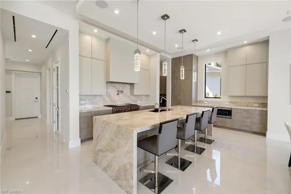 a large kitchen with a table and chairs