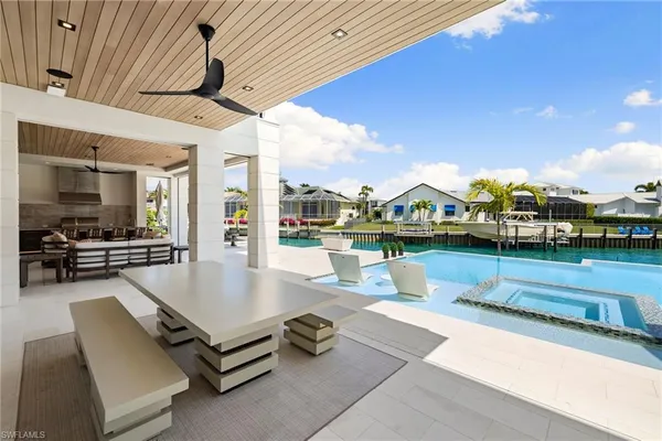 a swimming pool with outdoor seating and yard