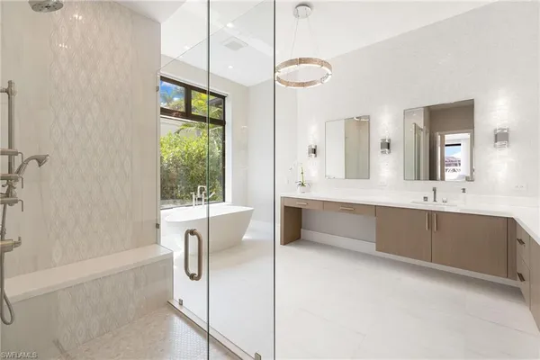 a large bathroom with a large tub and sink