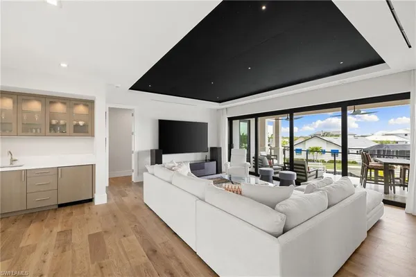 a living room with furniture large windows and a flat screen tv