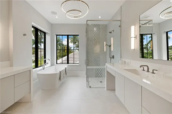 a bathroom with a bathtub shower sink and mirror