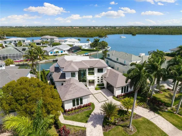 a view of a city with lawn chairs and large trees