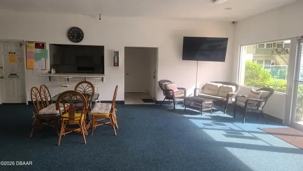 a view of washer and dryer with kitchen in the background