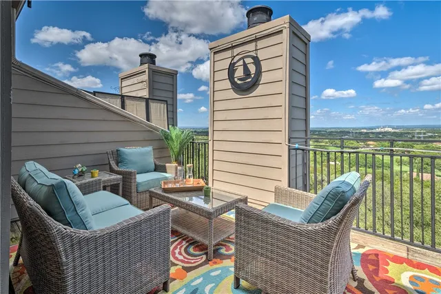 a view of a chairs and tables in the balcony