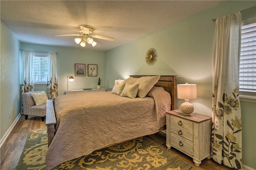 307 Poker Chip, Unit 122 Horseshoe Bay, TX 78657 - Photo 12 of 18 a bedroom with a bed and wooden floor