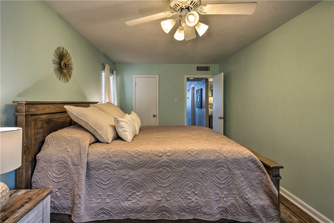 307 Poker Chip, Unit 122 Horseshoe Bay, TX 78657 - Photo 14 of 18 a bedroom with a bed and a chandelier
