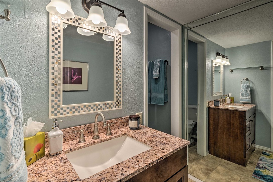 307 Poker Chip, Unit 122 Horseshoe Bay, TX 78657 - Photo 15 of 18 a bath room with a granite countertop sink and a mirror