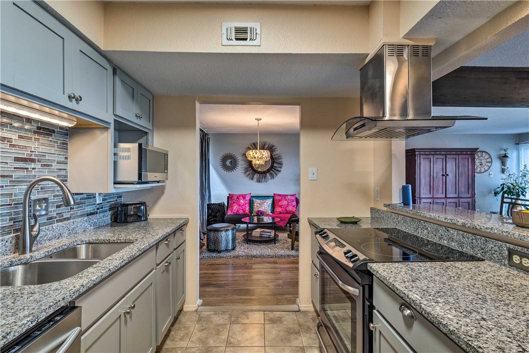 307 Poker Chip, Unit 122 Horseshoe Bay, TX 78657 - Photo 6 of 18 a kitchen with stainless steel appliances granite countertop a sink stove and refrigerator