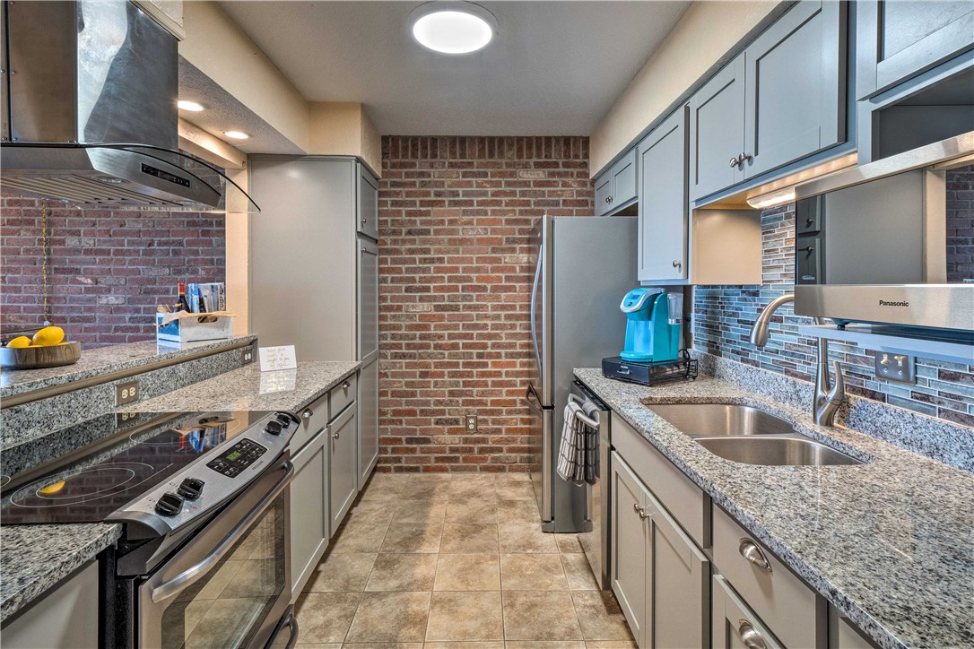 307 Poker Chip, Unit 122 Horseshoe Bay, TX 78657 - Photo 7 of 18 a kitchen with stainless steel appliances granite countertop a sink stove and refrigerator