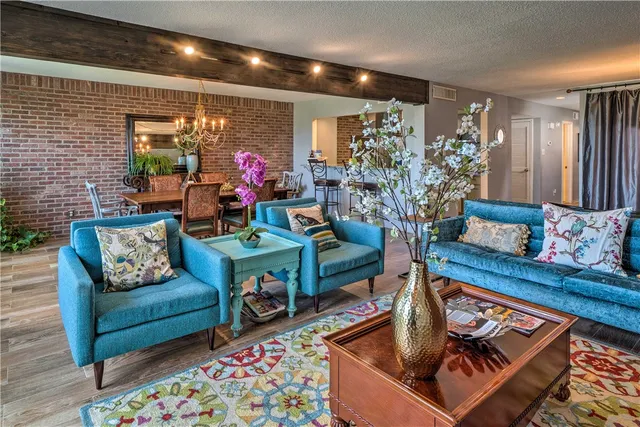 a living room with furniture a fireplace and a flat screen tv