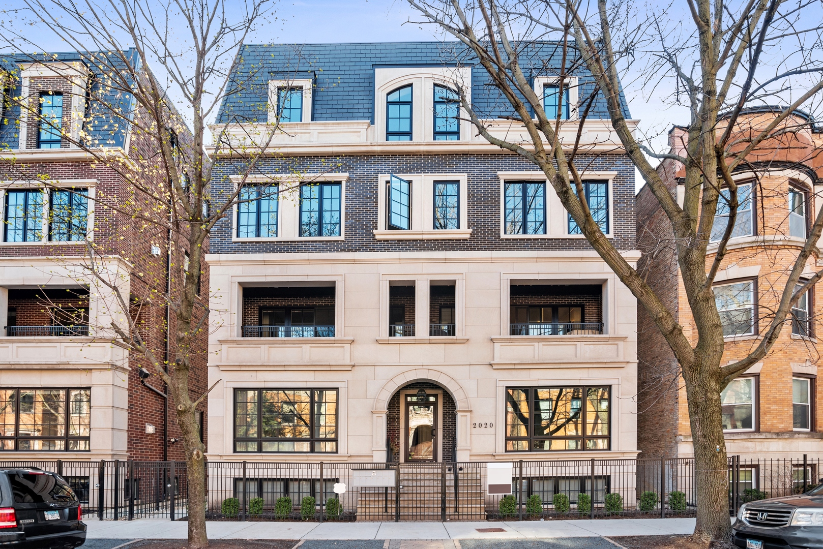 a front view of a residential apartment building with a yard